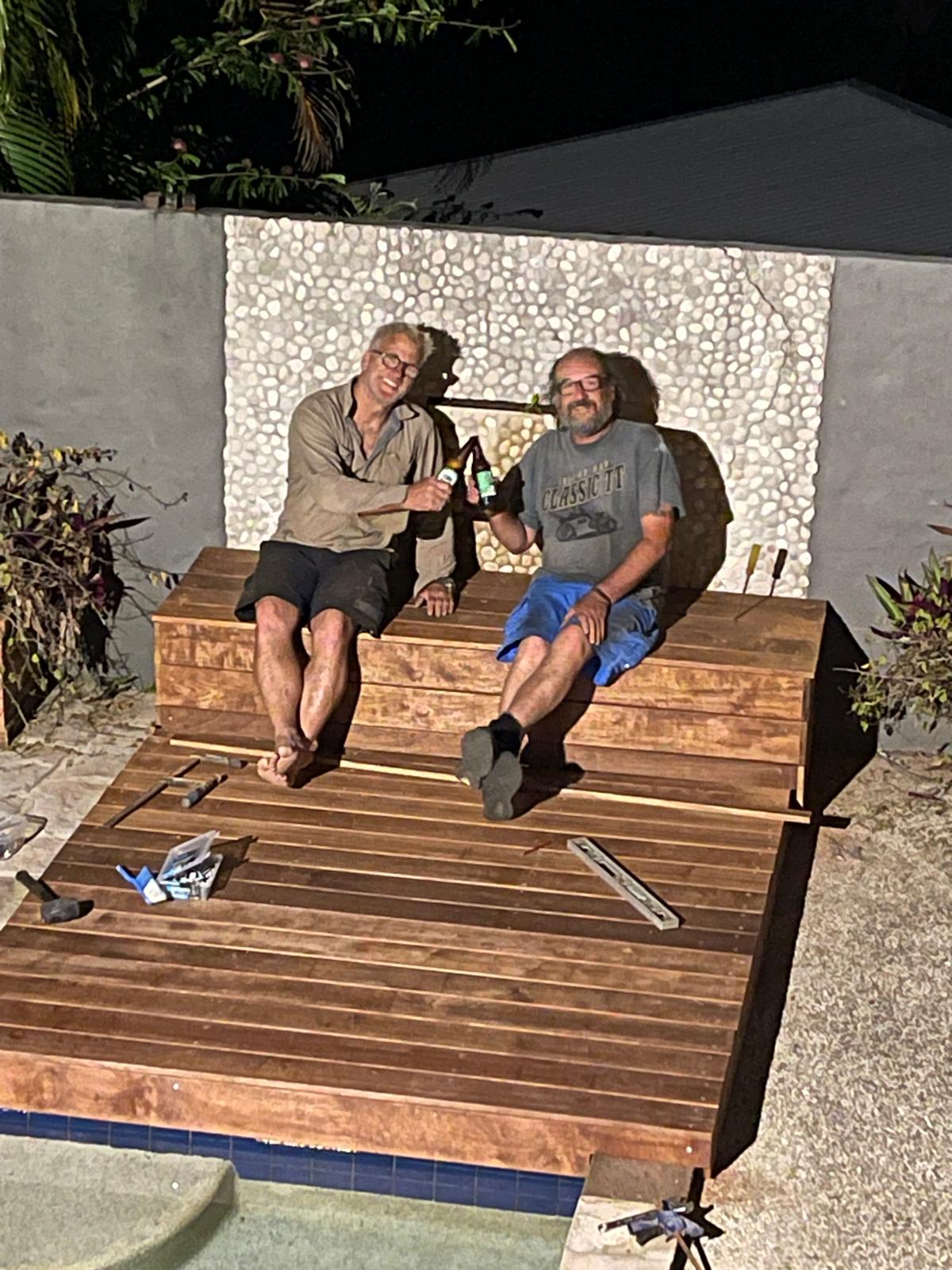 Scapem8 team members celebrating completion of a timber poolside deck
